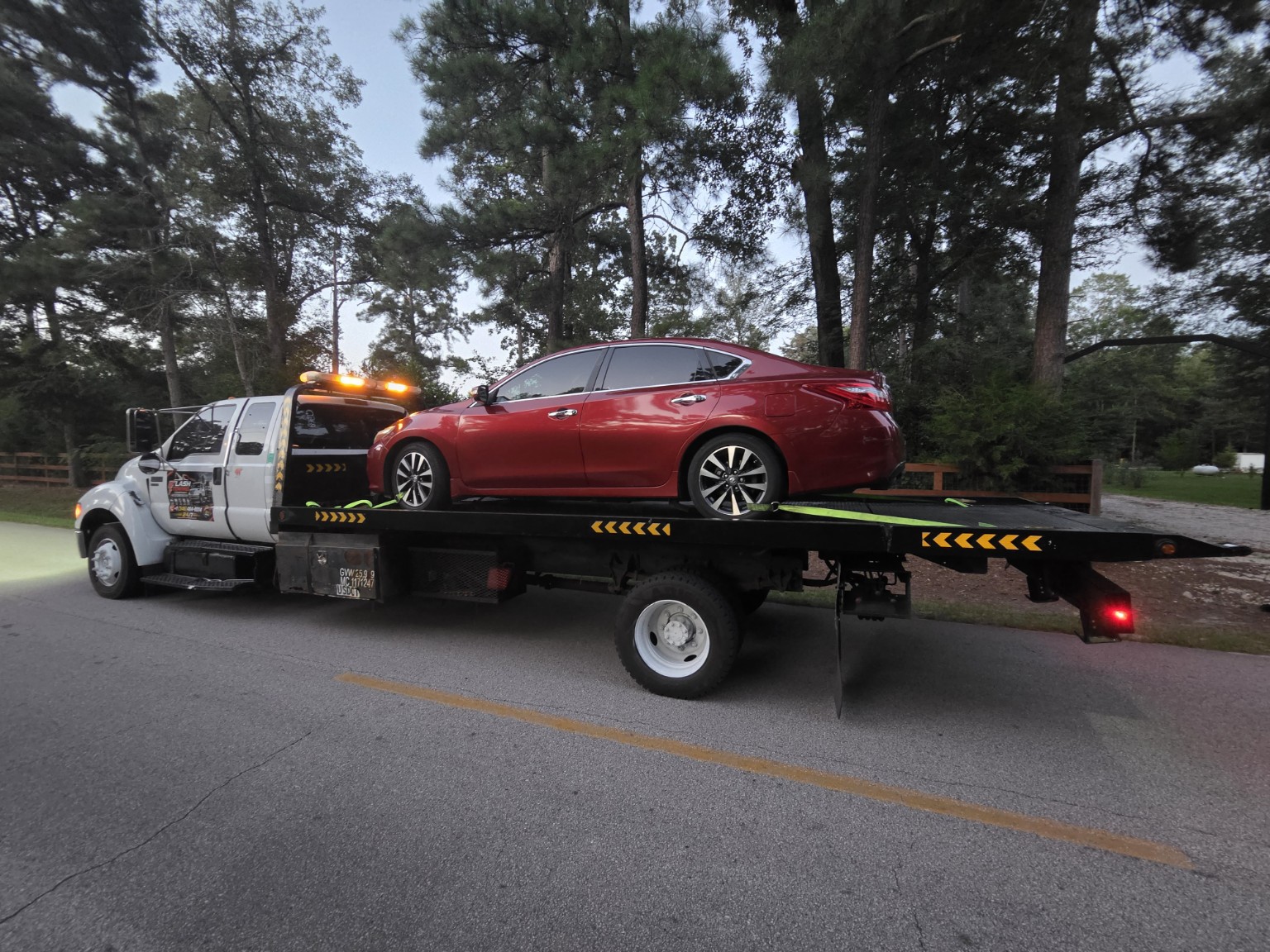 Red sedan on Flash Towing flatbed